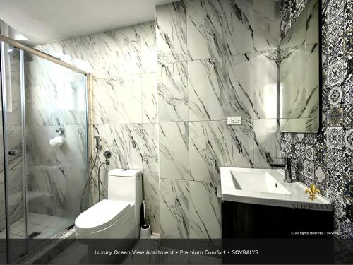 a bathroom with a toilet and a sink and a shower at 80M Luxury Ocean View Apartment PH The Sands, Next to Hilton in Panama City