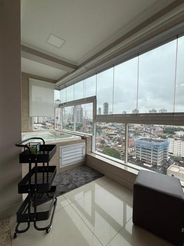 a large room with a large window with a bath tub at 01 Qt.| 2 Hosp. | Linda Vista | Jacuzzi Privativa in Goiânia