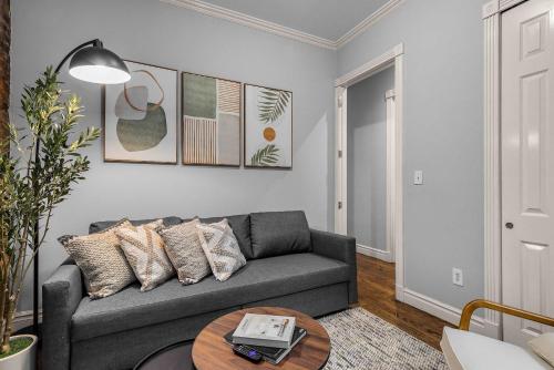 a living room with a couch and a table at Bold Manhattan Base in Prime Nolita in New York