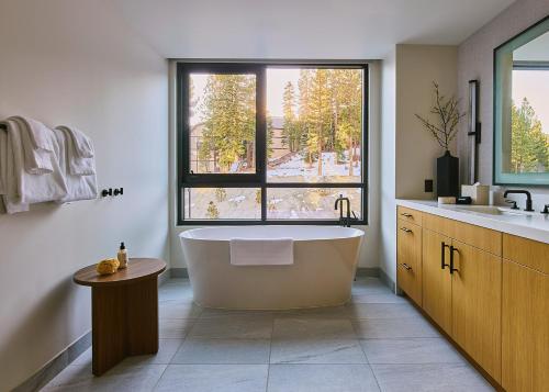 a large bathroom with a tub and a window at Limelight Mammoth in Mammoth Lakes