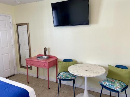 a room with a table and two chairs and a tv at Beachgate Condo Suites and Hotel 436 condo in Port Aransas