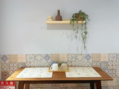 a wooden table with a tea kettle on it at HennaWatei in Osaka
