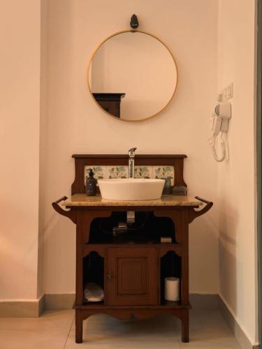a bathroom with a sink and a mirror at Villa Sethoskai -100m to Beach in Ambalangoda