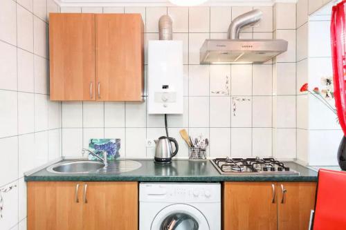 a kitchen with a sink and a washing machine at Apartment on Nezalezhnoy Ukrаiny near Intourist Hotel in Zaporozhye