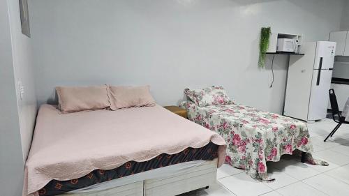 a small bedroom with a bed and a chair at Estúdio Completo in Marabá