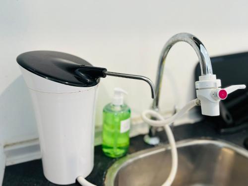 a kitchen sink with a faucet next to a sink at Pinnacle Pj by DeUrban in Petaling Jaya