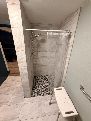 a shower with a glass door in a bathroom at Sin City Hostel in Las Vegas