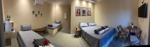 a hospital room with two beds and a sink at Margarida 02 in Monte das Gameleiras