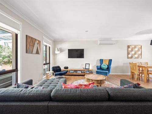 a living room with a couch and a table at Little Margs in Margaret River Town