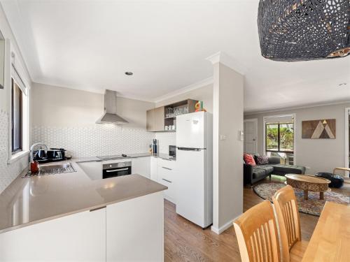 a kitchen and living room with a white refrigerator at Little Margs in Margaret River Town