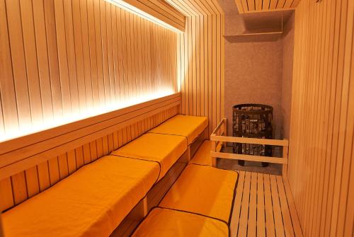 a sauna with a bench in a room at Hotel Global View Tsuchiura in Tsuchiura
