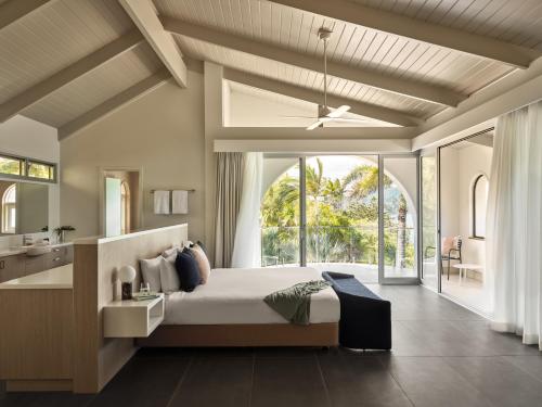 a bedroom with a bed and a large window at Hamilton Island Holiday Homes in Hamilton Island