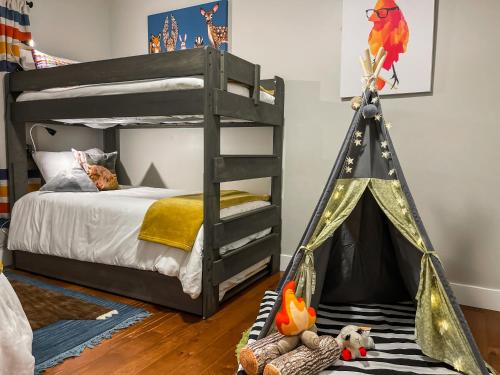 a bedroom with a bunk bed with a parrot tent at Mountain View Adventures in Heber City