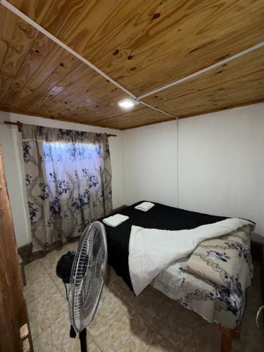 a room with a bed and a fan in it at Complejo Indanna in San Rafael