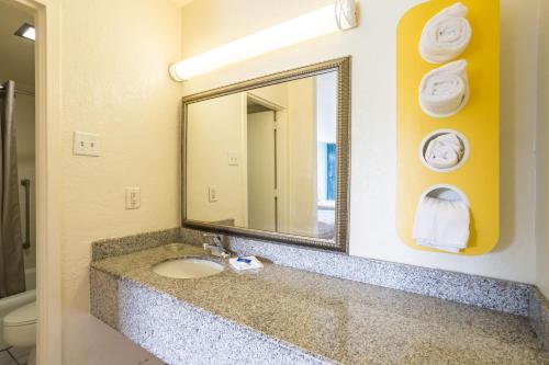 a bathroom with a sink and a mirror at Motel 6-Spring Hill, FL - Weeki Wachee in Weeki Wachee