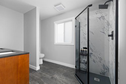a bathroom with a shower and a toilet at Maple Street Retreat in Bellaire