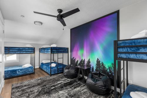 a room with two bunk beds and a large screen at Maple Street Retreat in Bellaire