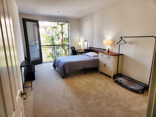 a bedroom with a bed and a large window at Irvine Spectrum 1 bed 1 bath in Irvine