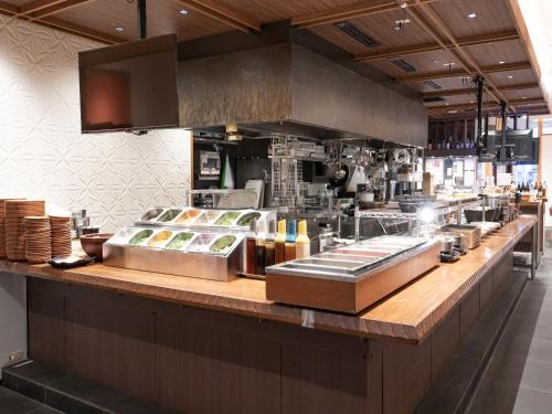 a kitchen with a counter with food on it at APA Hotel Sugamo Ekimae in Tokyo