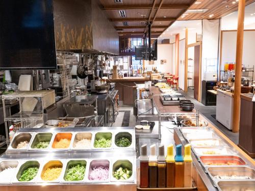 a large kitchen with a lot of food at APA Hotel Sugamo Ekimae in Tokyo