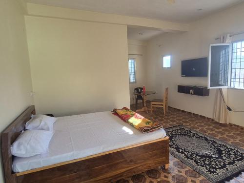 a bedroom with a bed and a table in it at Roaming Rovers - Pet-Friendly & Peaceful Homestay in Almora in Almora