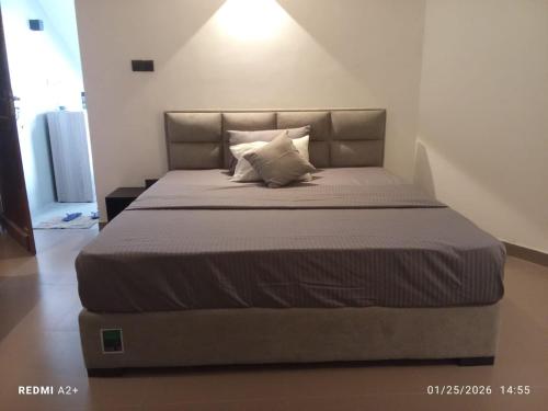 a bedroom with a large bed with a large headboard at ARHH castle in Ginigathena