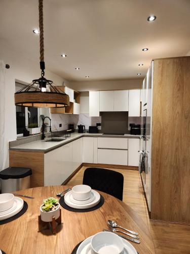 a kitchen and dining room with a wooden table at Kashkana Haven - Blackburn in Cherry Tree
