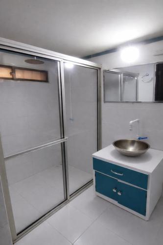a bathroom with a sink and a shower at QuillaHost Guesthouse in Barranquilla