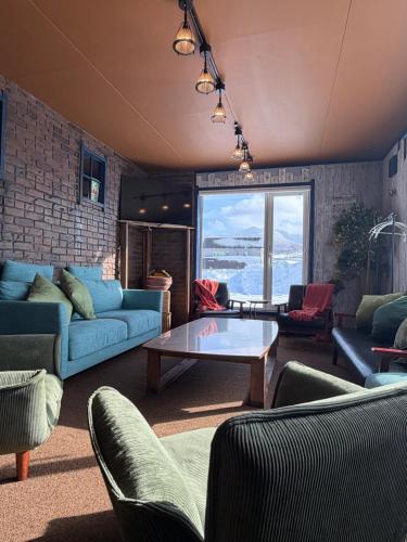 a living room with couches and a table at Rusutsu Ski Stay111 in Rusutsu