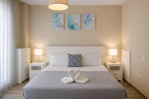 a bedroom with a bed with two white towels on it at AYZ Villegas - Auto check-in property in Madrid