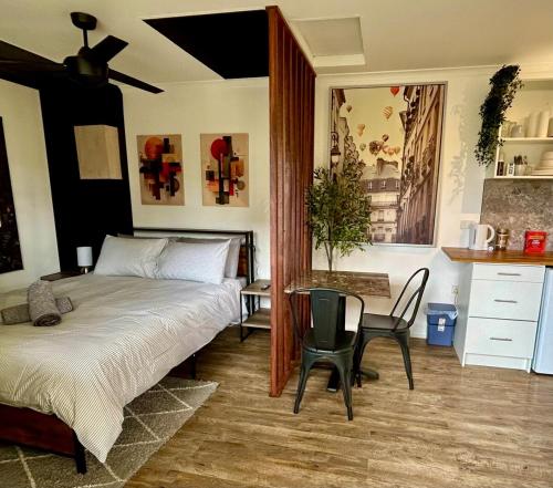 a bedroom with a bed and a table and chairs at Guest House in East Devonport in Devonport