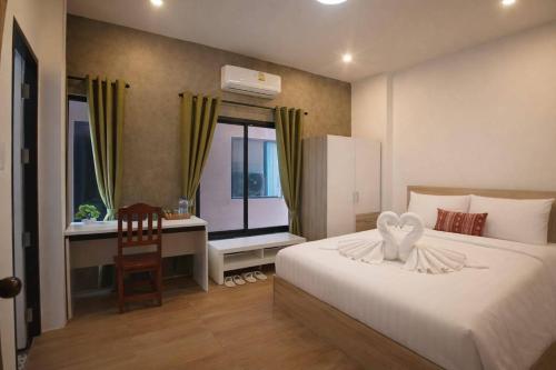 a bedroom with a bed and a desk and a window at River Bend villas 1 in Mae Rim