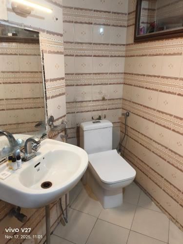 a bathroom with a toilet and a sink at Riddhi Guest House in Udaipur