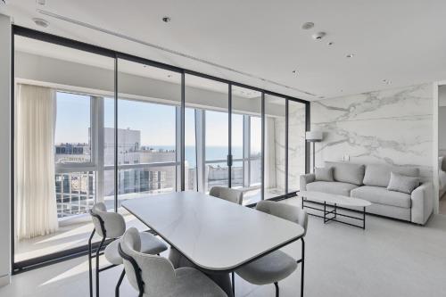 a living room with a table and chairs and a couch at Palatium Haeundae by SONO Felice in Busan