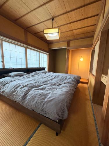 a bedroom with a large bed in a room at North Nagano Inn in Iiyama
