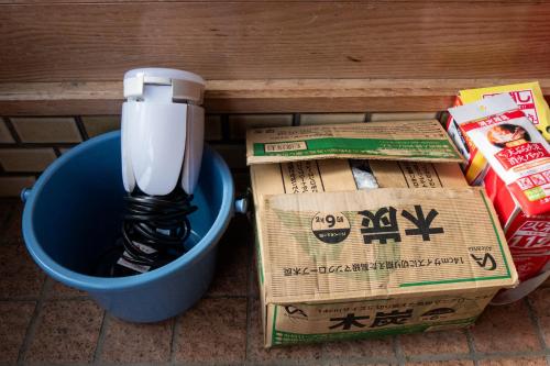 a light in a trash can next to boxes at #23 -玉島茶室- 歴史を感じるTea Room ペット同伴 BBQ可 in Nagao