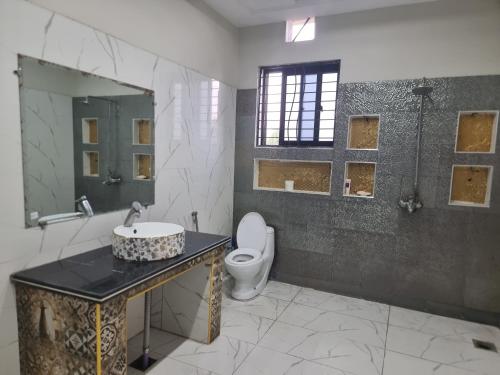 a bathroom with a sink and a toilet at Elegance Abounds in Qila Malla Singh