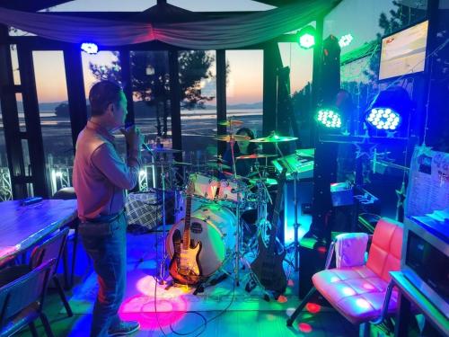a man standing in a room with a drum set at Seosan View Live in Seosan