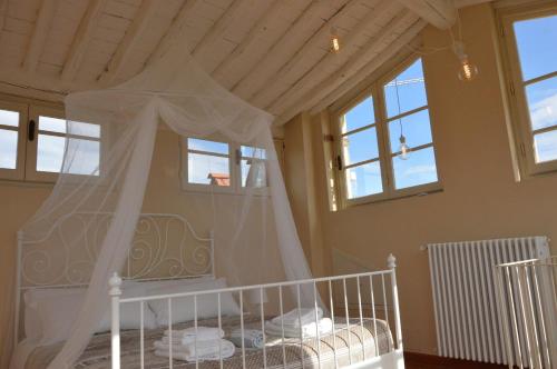 a bedroom with a bed with a mosquito net at Corte San Lazzaro in Lucca