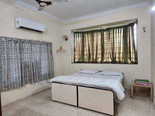 a bedroom with a white bed and a window at Contemporary comfort in Kākināda