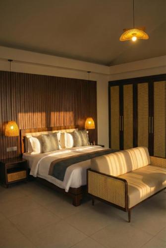 a large bedroom with a large bed and a couch at Amayi Resort Nusa Dua in Nusa Dua