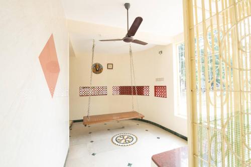 a room with a swing and a window at Thaayar Homestay by Highpoint in Tiruchirappalli