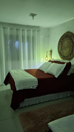 a bedroom with a large bed and a window at Morada Héstia in Imbé