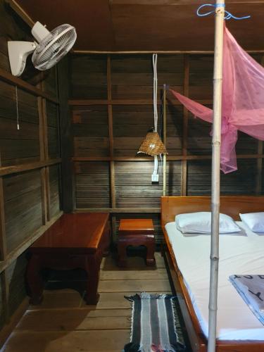 a room with two beds and a table and a lamp at Banlung Mountain View Treks & Tours in Banlung