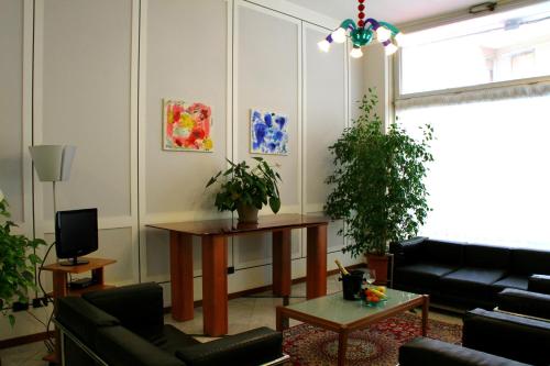 a living room with a couch and a table at Domus Hotel in Alessandria