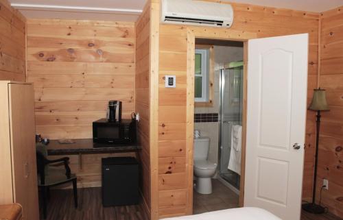 a room with a bathroom with a toilet and a desk at Motel 149 in Mont-Tremblant