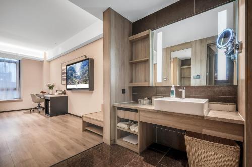 a bathroom with a sink and a mirror at 成都高新天府三街亚朵酒店 in Chengdu