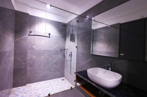 a bathroom with a sink and a shower at Kaara Gurgaon in Gurgaon