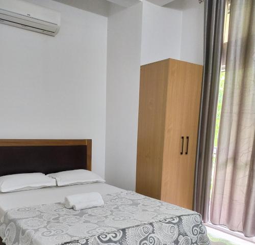 a bedroom with a bed and a window at Viki homestay in Dimapur