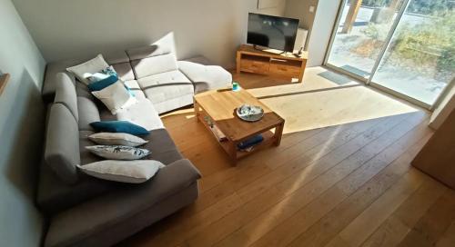 a living room with a couch and a coffee table at Le Trible in Labeaume